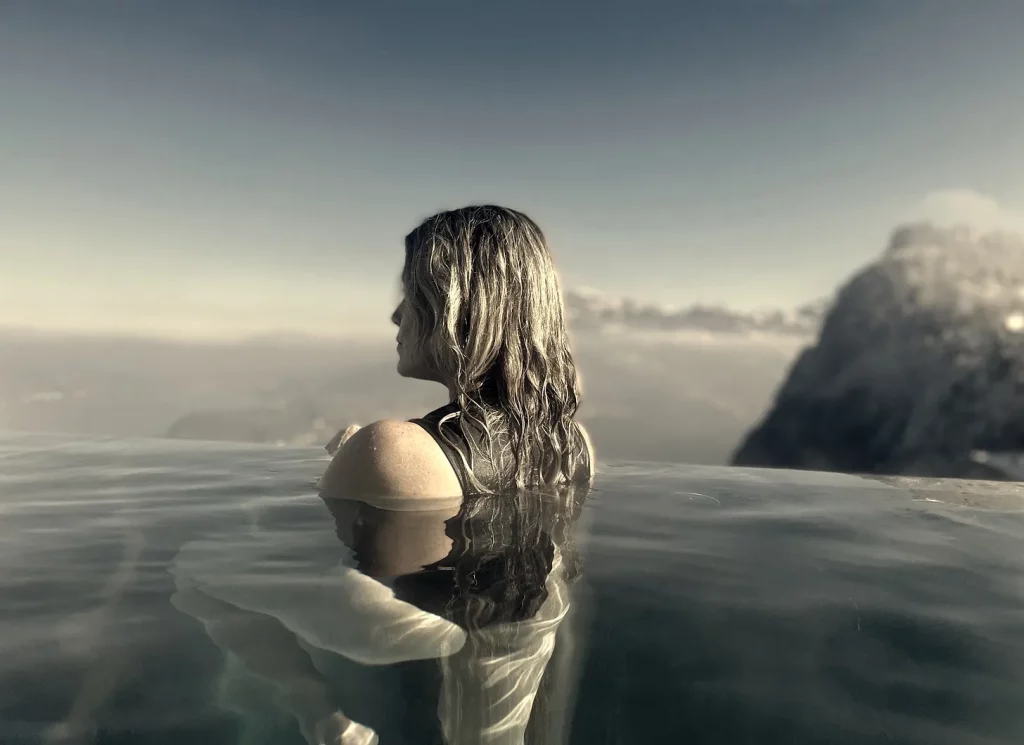 Meggen Harris looking out over the mountains from an infinity pool at Bürgenstock in Switzerland.